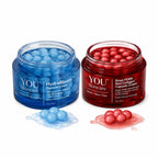 Two jars of YOU Skincare cream, one blue and one red, with capsules on a white background.