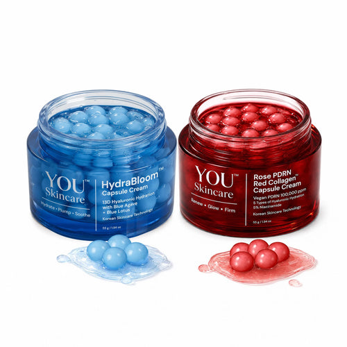 Two jars of YOU Skincare cream, one blue and one red, with capsules on a white background.