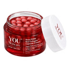 A clear cosmetic jar filled with red gelatin capsules, shown with its white lid leaning against it on a white background. The label reads YOU Skincare Rose PDRN Red Collagen Capsule Cream.