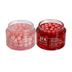 Two clear cosmetic jars filled with pink/red capsules on a white reflective background. The left jar is labeled YOU Skincare GlowCaps and the right jar is labeled YOU Skincare Rose DORN Red Collagen Capsule Cream.
