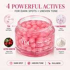 A jar of YOU Skincare GlowCaps Dark Spot Correcting Cream shown on a light beige background with marketing callouts for TXA, niacinamide, alpha arbutin, and glutathione, plus text reading '4 POWERFUL ACTIVES FOR DARK SPOTS + UNEVEN TONE'.