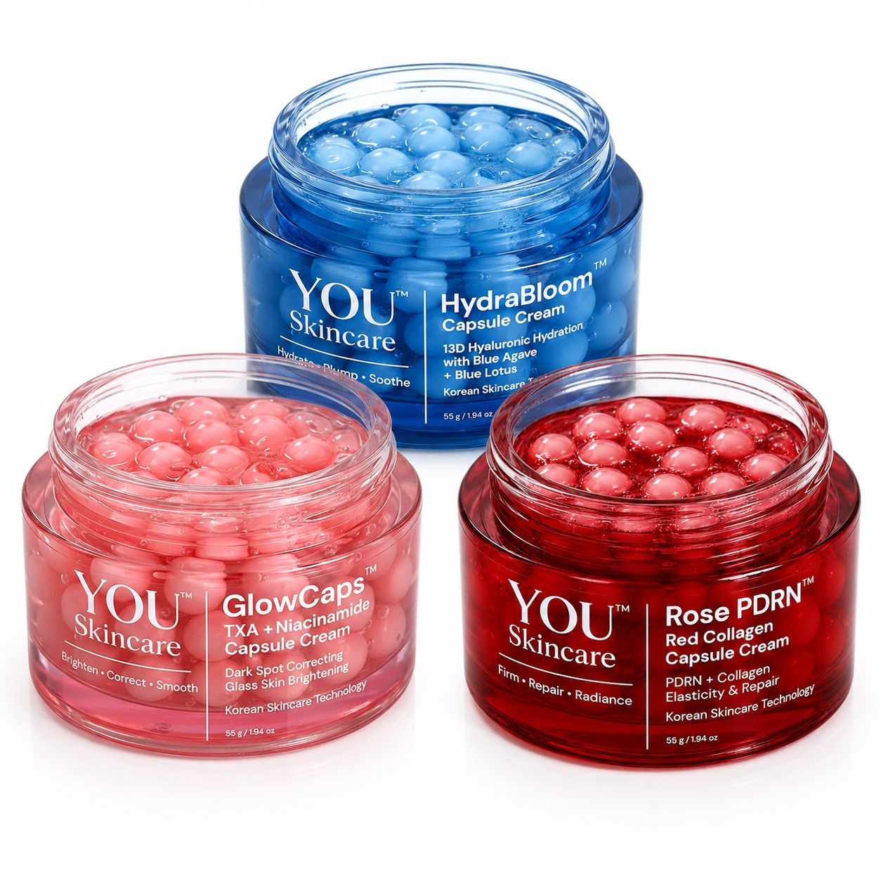 Three open cosmetic capsule jars on a white background: a blue jar labeled HydraBloom Capsule Cream in the back, and two pink/red jars in front labeled GlowCaps and Rose PDRN capsules.