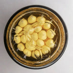 top view of vitamin C capsule cream jar showing multiple capsules inside gel formula for stability and freshness